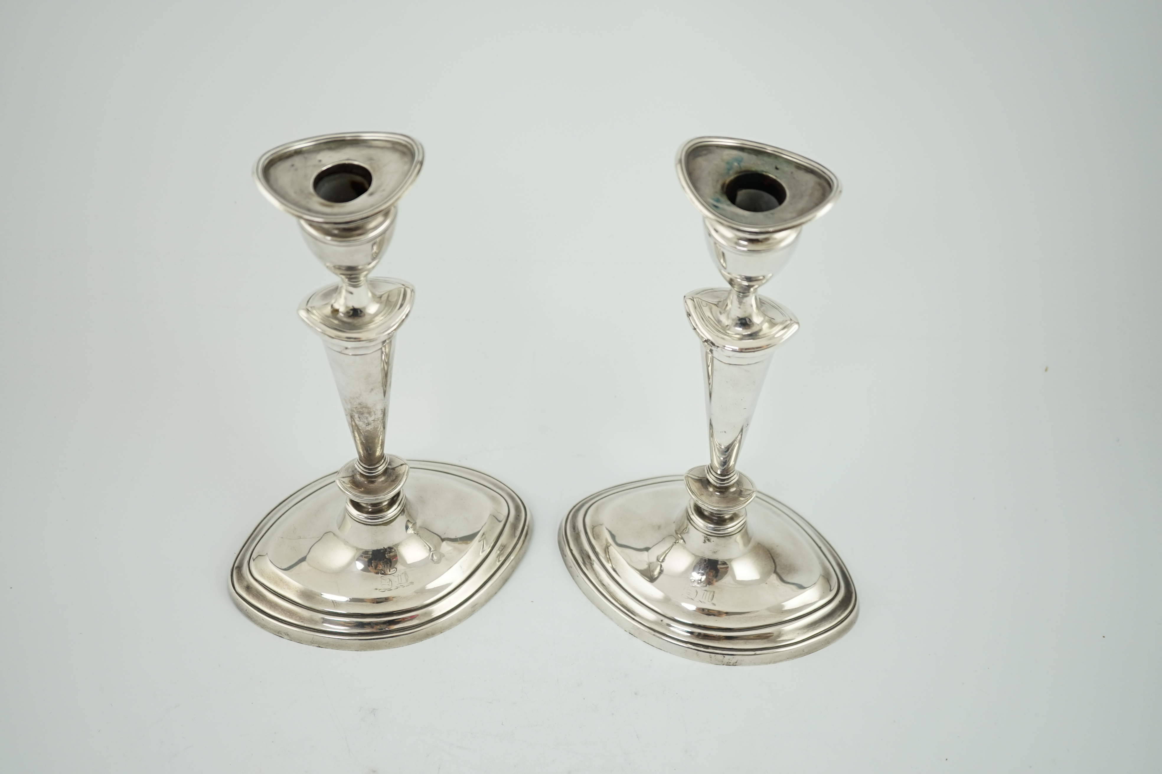 A pair of late Victorian silver oval candlesticks by Goldsmiths & Silversmiths (Gibson & Langman)